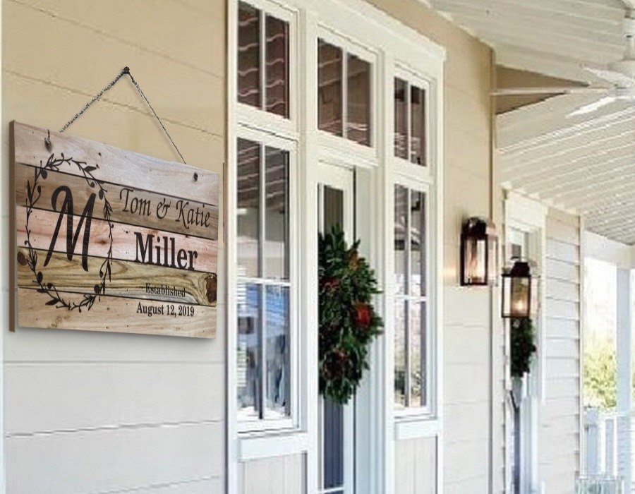 Personalized family name sign hanging on a porch
