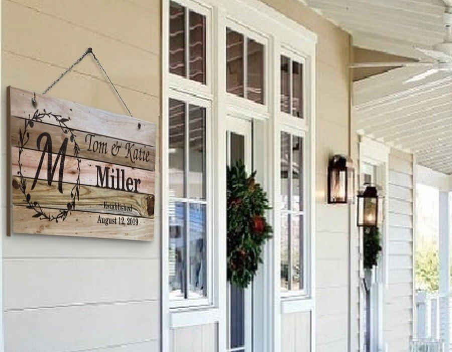 Personalized family name sign hanging on a porch